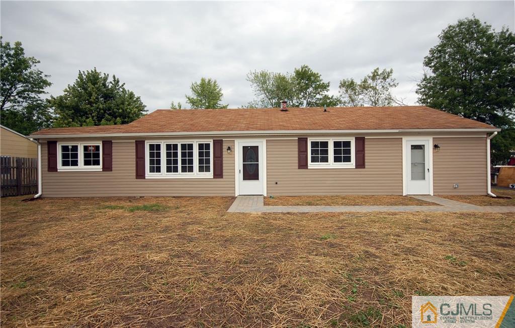 1227 Brookside Road Piscataway, NJ 08854 - Photo 1 of 22 a front view of a house with a garden