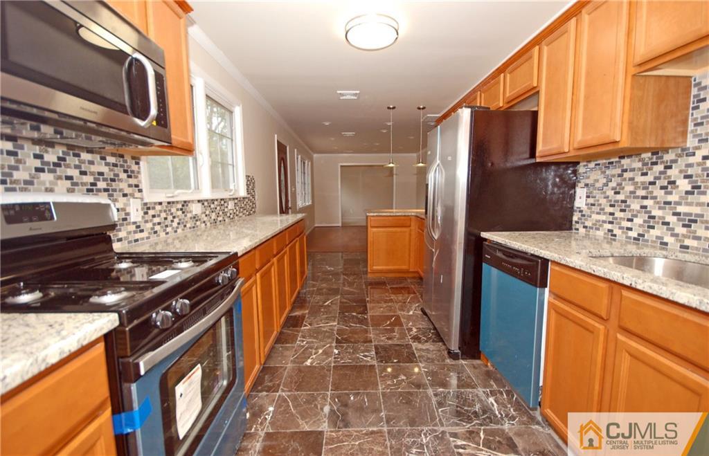 1227 Brookside Road Piscataway, NJ 08854 - Photo 2 of 22 a kitchen with stainless steel appliances granite countertop a stove and a sink