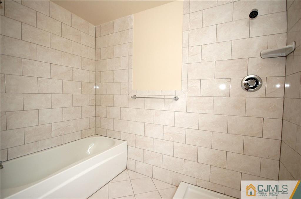 1227 Brookside Road Piscataway, NJ 08854 - Photo 16 of 22 a bathroom with a bathtub and shower