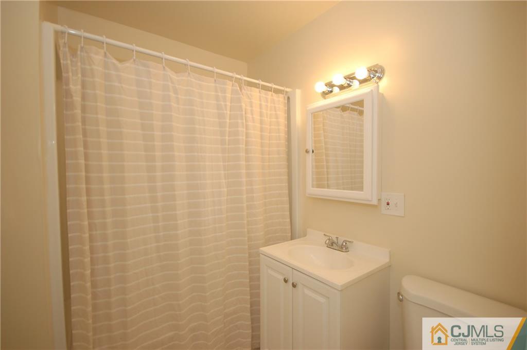 1227 Brookside Road Piscataway, NJ 08854 - Photo 17 of 22 a bathroom with a sink a vanity and a shower