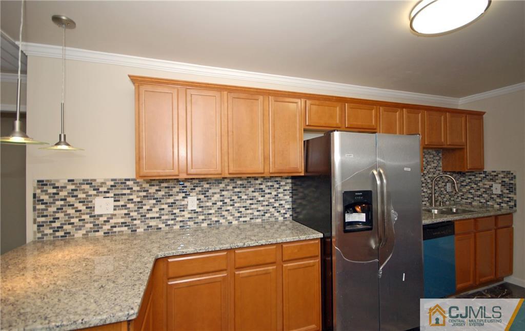 1227 Brookside Road Piscataway, NJ 08854 - Photo 4 of 22 a kitchen with a refrigerator and a stove top oven