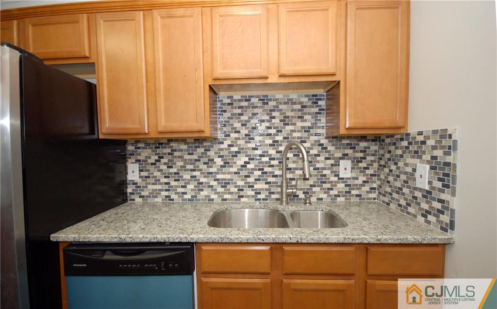 1227 Brookside Road Piscataway, NJ 08854 - Photo 5 of 22 a kitchen with granite countertop a sink and a stove