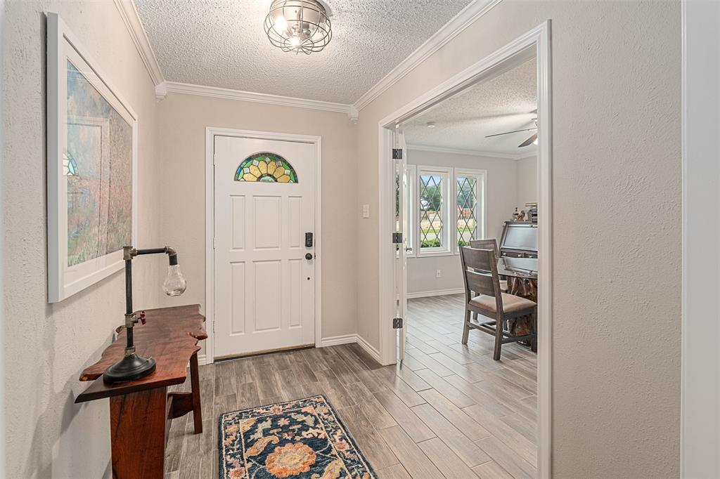 1102 Mill Run Road Athens, TX 75751 - Photo 2 of 35 a view of a hallway with wooden floor and a livingroom with furniture