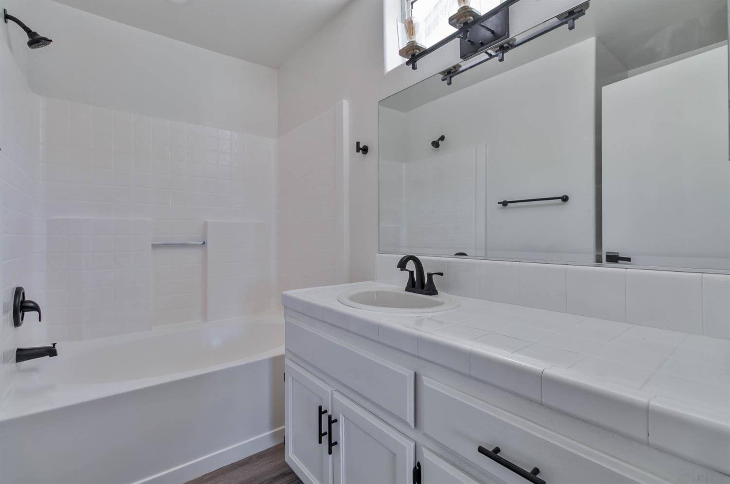 7110 Firebaugh Street Bakersfield, CA 93313 - Photo 15 of 37 a bathroom with a sink and a bathtub