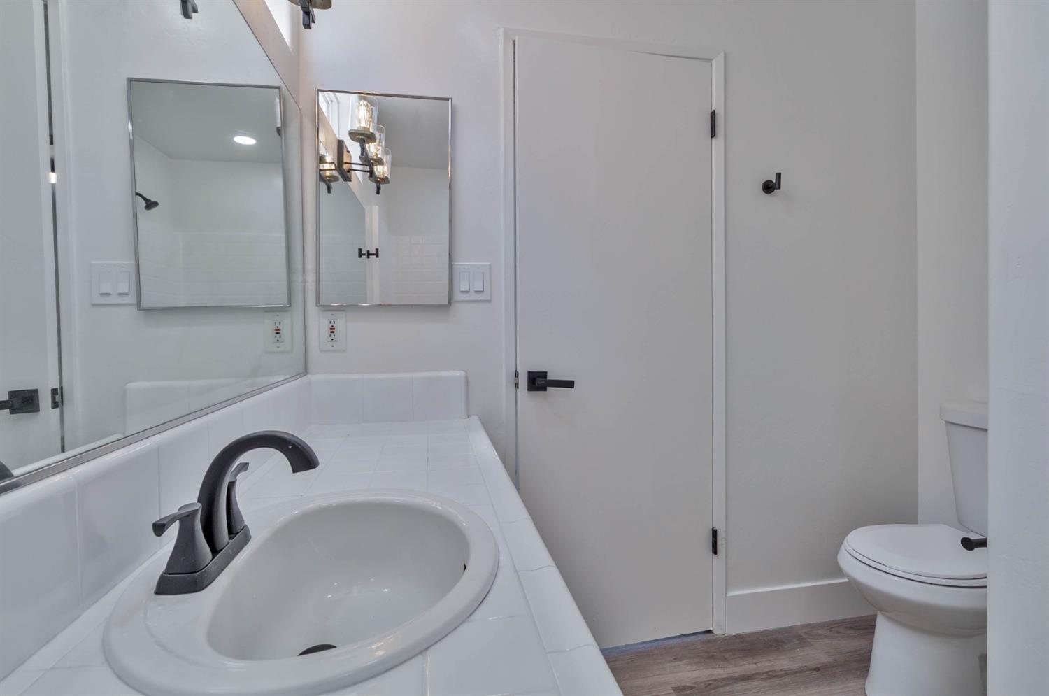 7110 Firebaugh Street Bakersfield, CA 93313 - Photo 16 of 37 a bathroom with a sink a toilet and shower