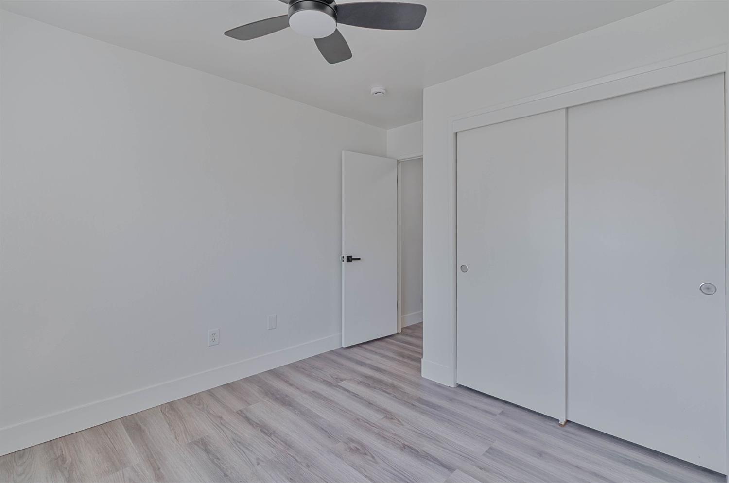 7110 Firebaugh Street Bakersfield, CA 93313 - Photo 21 of 37 a view of an empty room with wooden floor