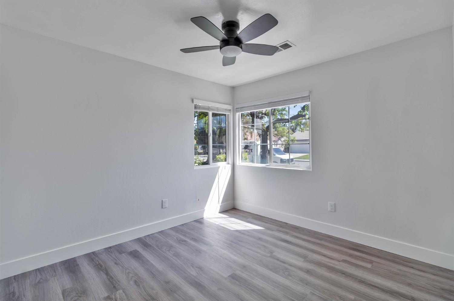 7110 Firebaugh Street Bakersfield, CA 93313 - Photo 22 of 37 wooden floor in an empty room with a window