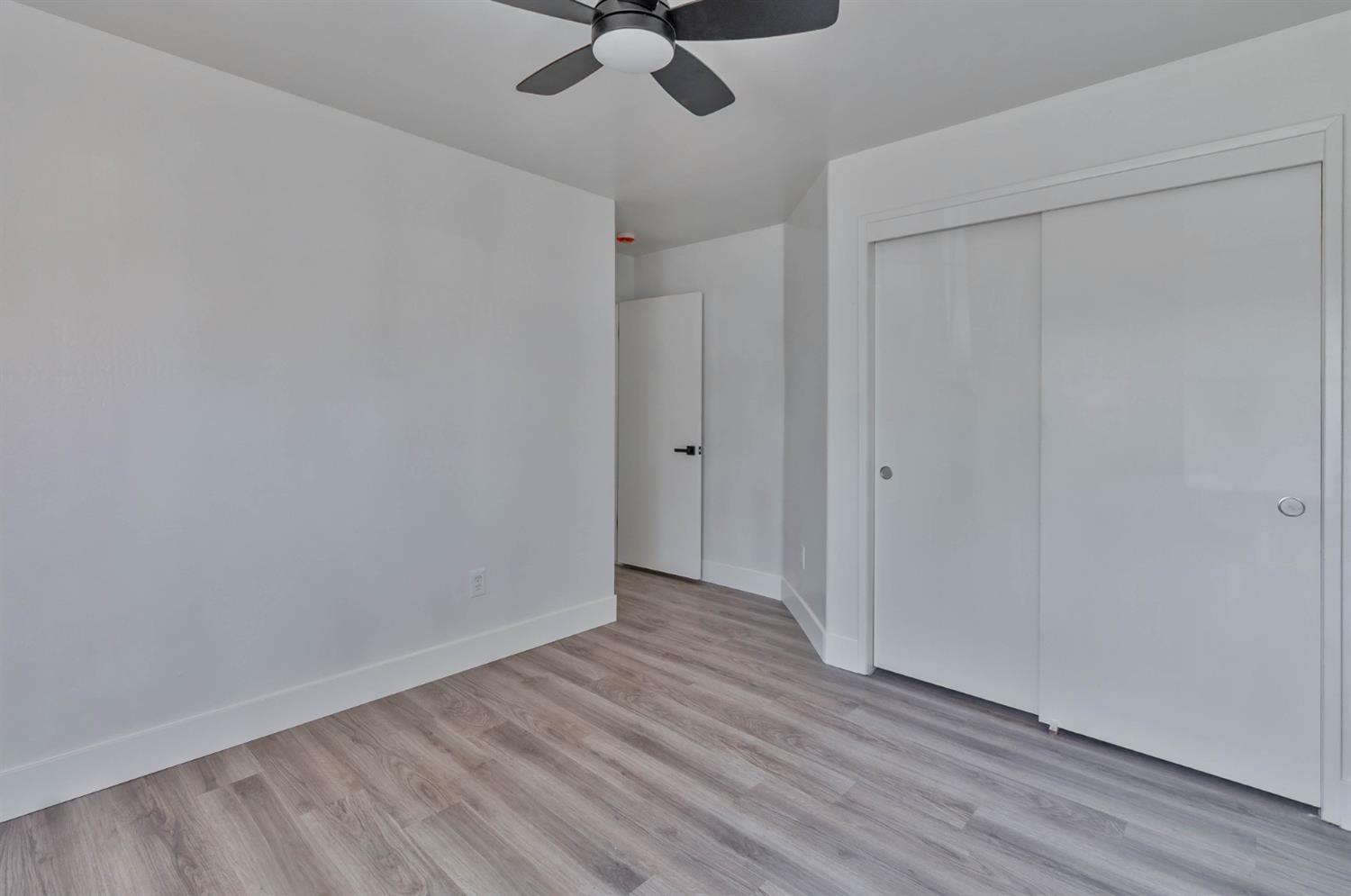 7110 Firebaugh Street Bakersfield, CA 93313 - Photo 23 of 37 a view of a room with wooden floor