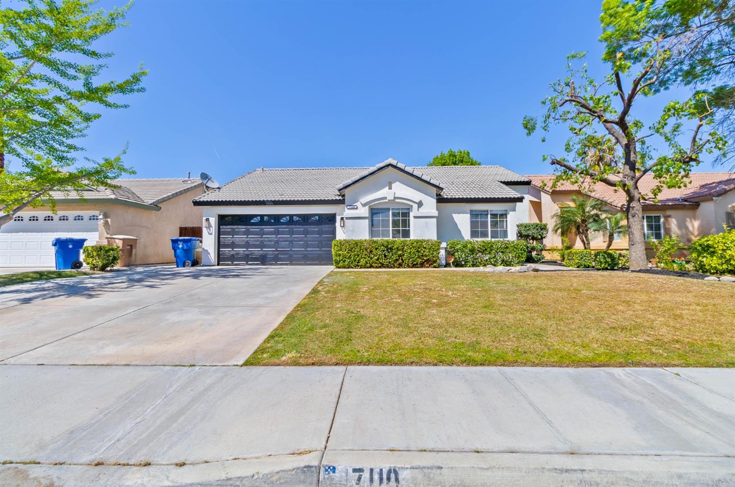 7110 Firebaugh Street Bakersfield, CA 93313 - Photo 30 of 37 a front view of a house with a yard