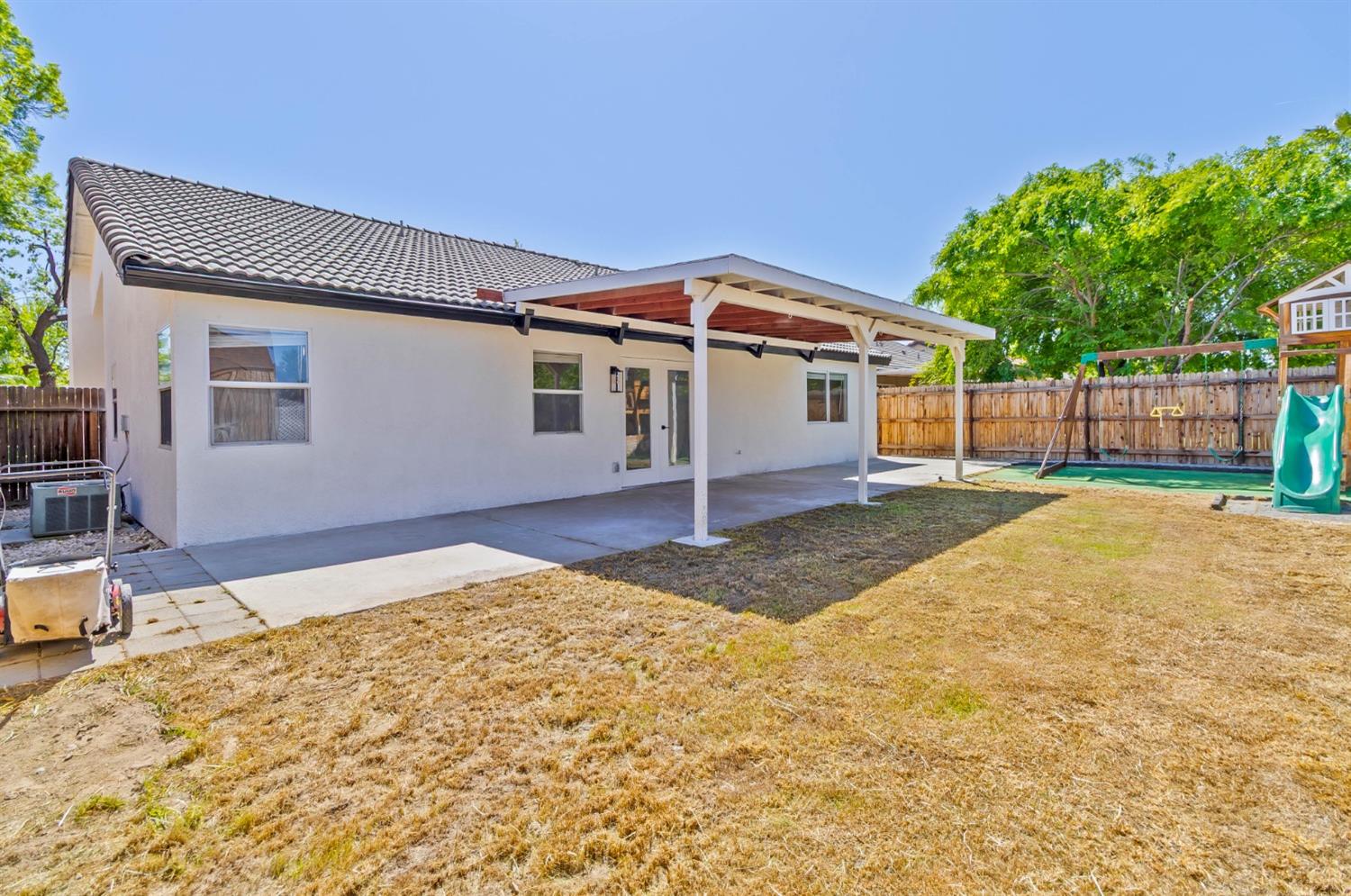 7110 Firebaugh Street Bakersfield, CA 93313 - Photo 34 of 37 a view of a house with a yard and potted plants