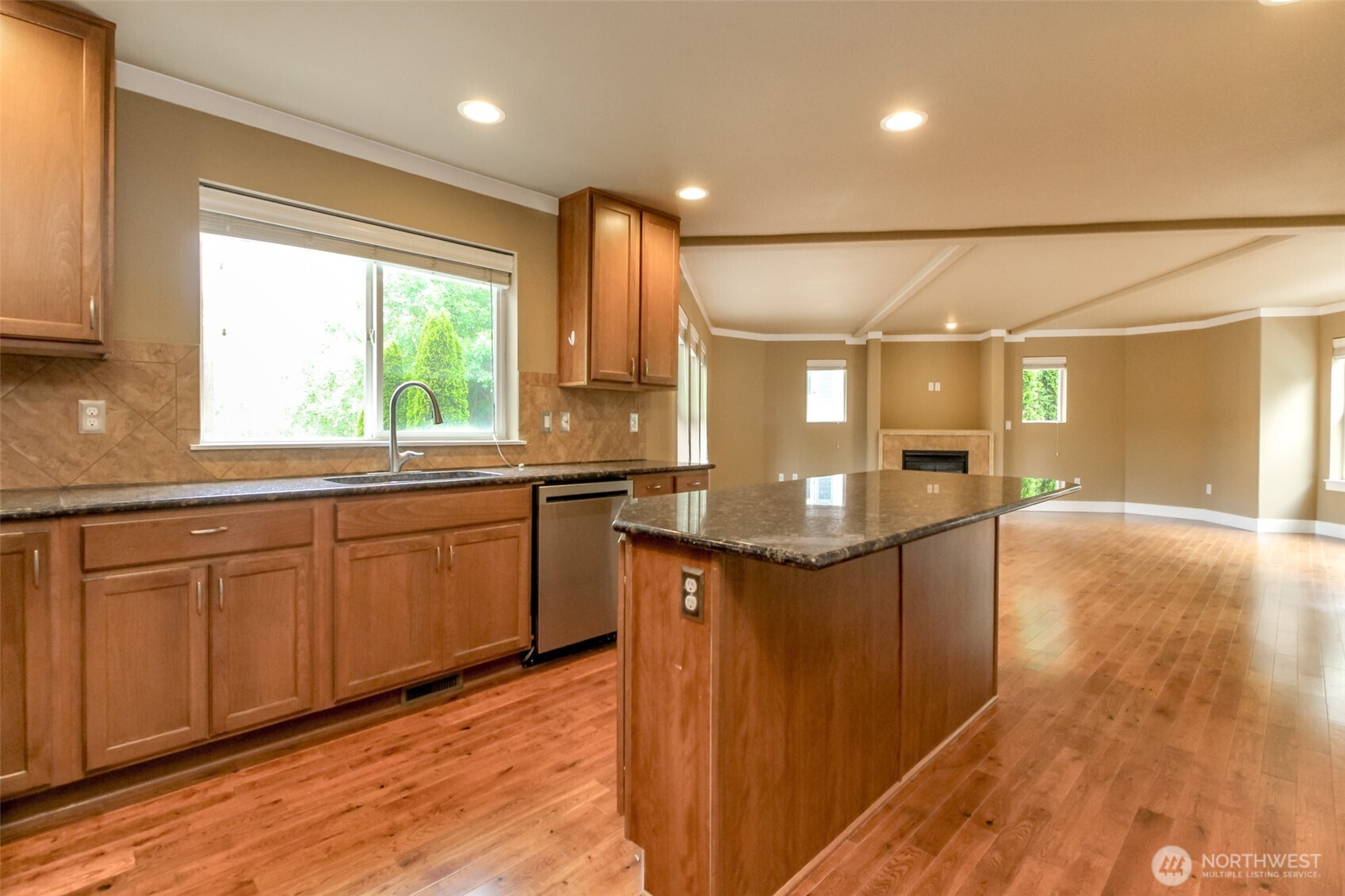 3000 South Mt Baker Boulevard Seattle, WA 98144 - Photo 15 of 40 a kitchen with kitchen island granite countertop a sink and wooden cabinets