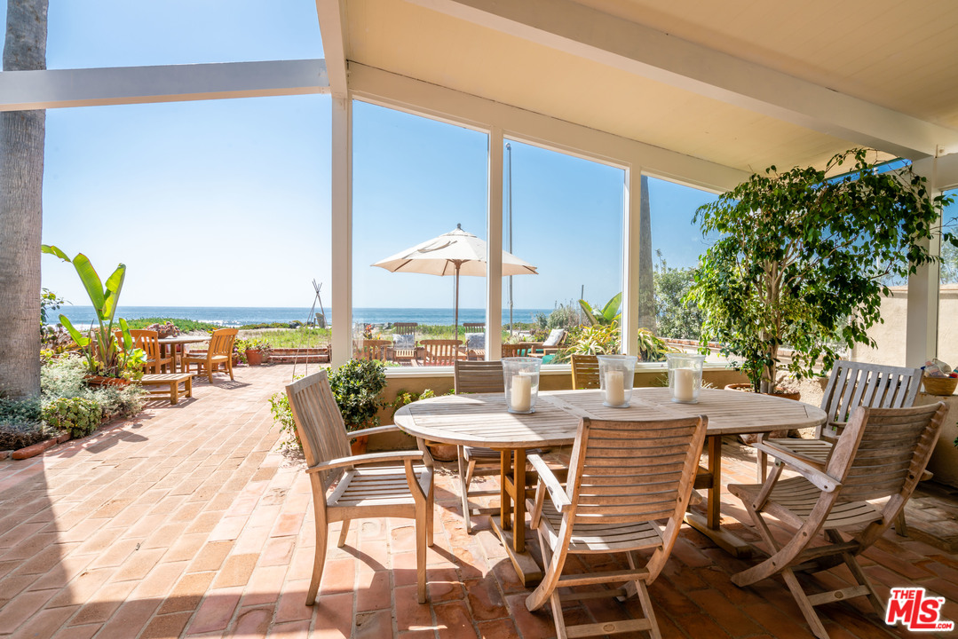 31034 Broad Beach Road Malibu, CA 90265 - Photo 6 of 23 a view of a swimming pool with outdoor seating and plants