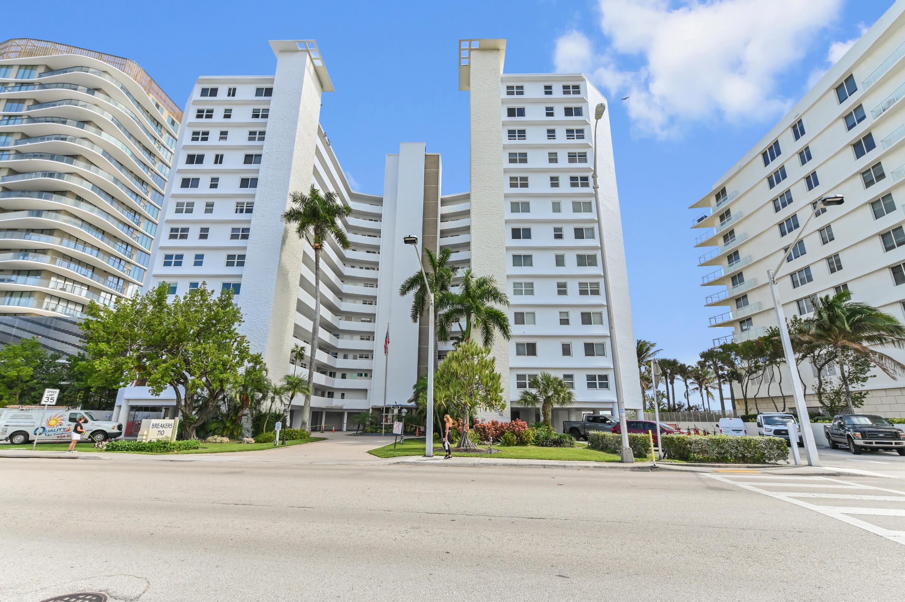 710 North Ocean Boulevard, Unit 710 Pompano Beach, FL 33062 - Photo 2 of 42 a tall building sitting on the side of a street