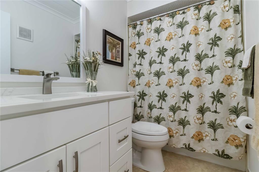 2240 Stickney Point Road, Unit 238 Sarasota, FL 34231 - Photo 11 of 17 a bathroom with a sink a toilet and a mirror