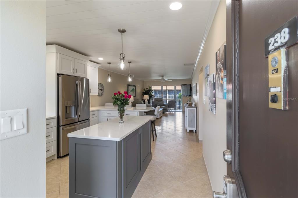 2240 Stickney Point Road, Unit 238 Sarasota, FL 34231 - Photo 2 of 17 a kitchen with kitchen island a sink stove and refrigerator