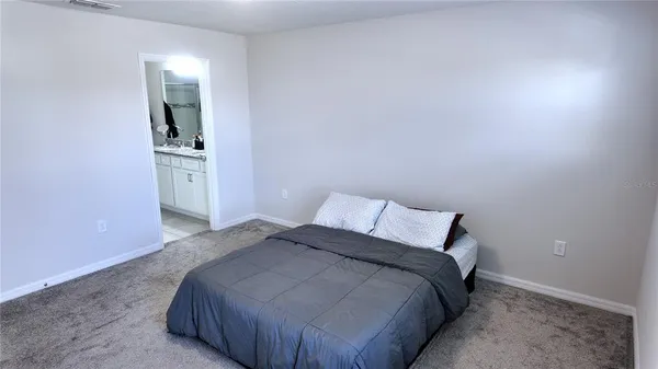 a bedroom with a bed and a mirror