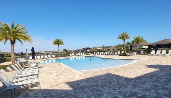 a view of swimming pool with outdoor seating