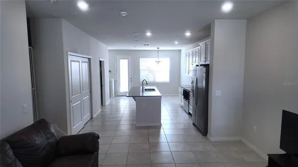 a view of a hallway with furniture and a livingroom