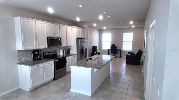 a large kitchen with stainless steel appliances lots of counter top space