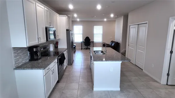 a large white kitchen with a large window
