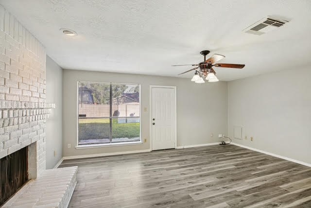 3715 Wells Mark Drive Humble, TX 77396 - Photo 12 of 16 a view of empty room with wooden floor and fan
