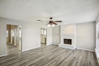 3715 Wells Mark Drive Humble, TX 77396 - Photo 15 of 16 a view of empty room with wooden floor and fireplace