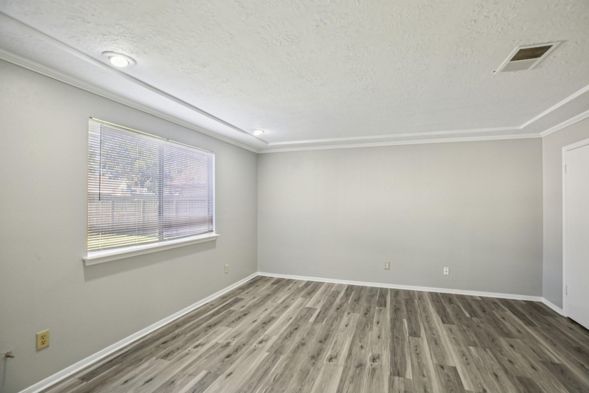 3715 Wells Mark Drive Humble, TX 77396 - Photo 5 of 16 an empty room with wooden floor and windows