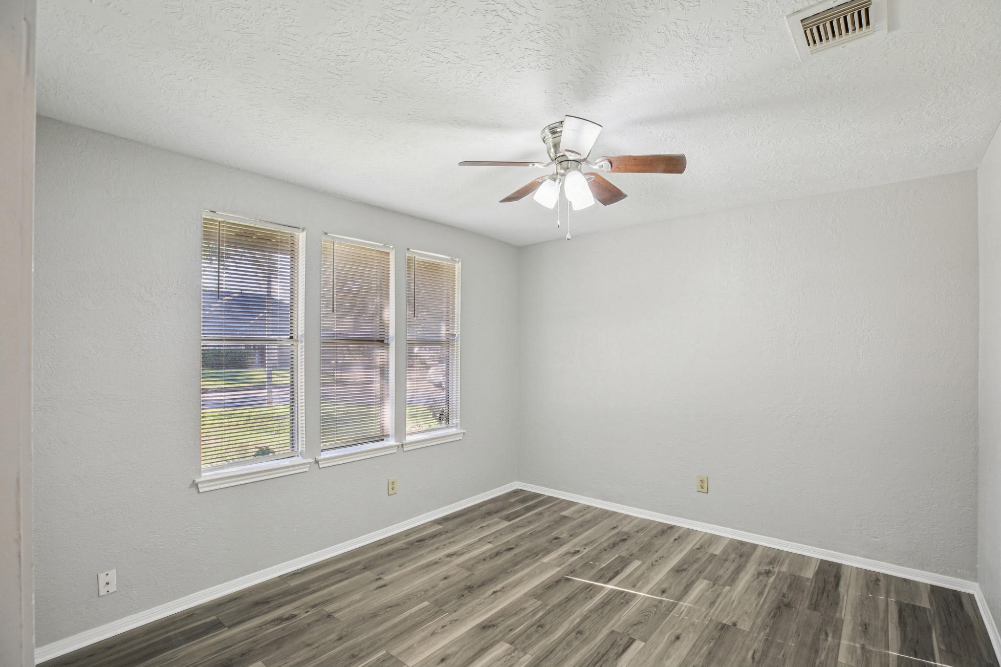 3715 Wells Mark Drive Humble, TX 77396 - Photo 6 of 16 a view of empty room with wooden floor and fan
