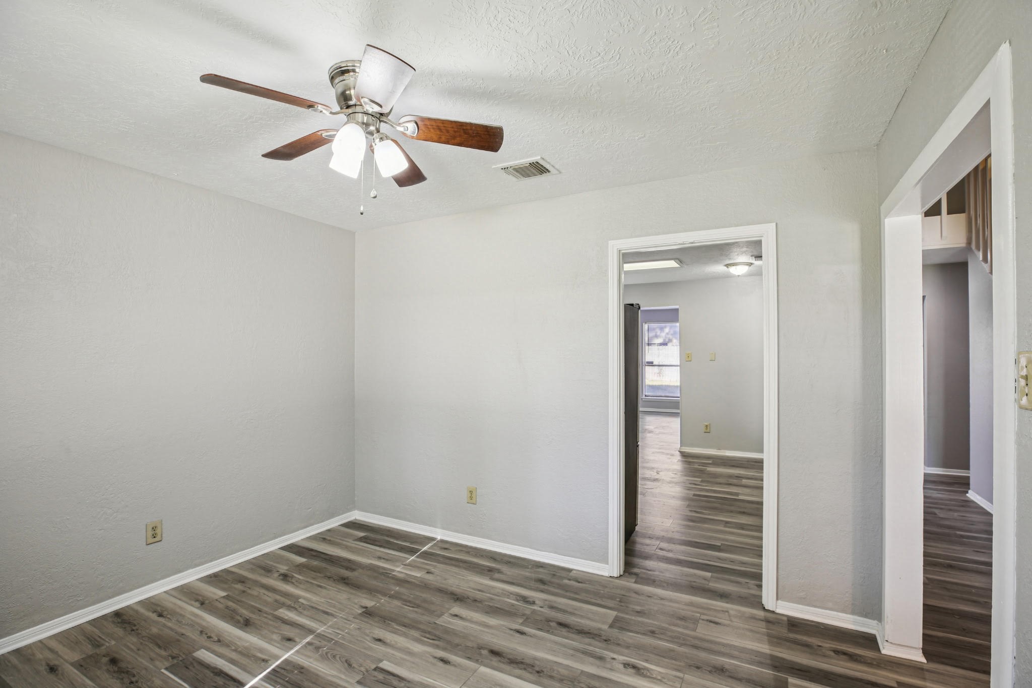 3715 Wells Mark Drive Humble, TX 77396 - Photo 9 of 16 an empty room with wooden floor fan and windows