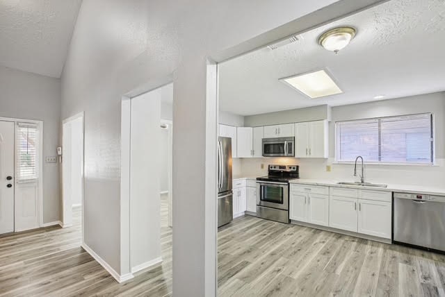 3715 Wells Mark Drive Humble, TX 77396 - Photo 10 of 16 a kitchen with stainless steel appliances granite countertop a stove and a sink