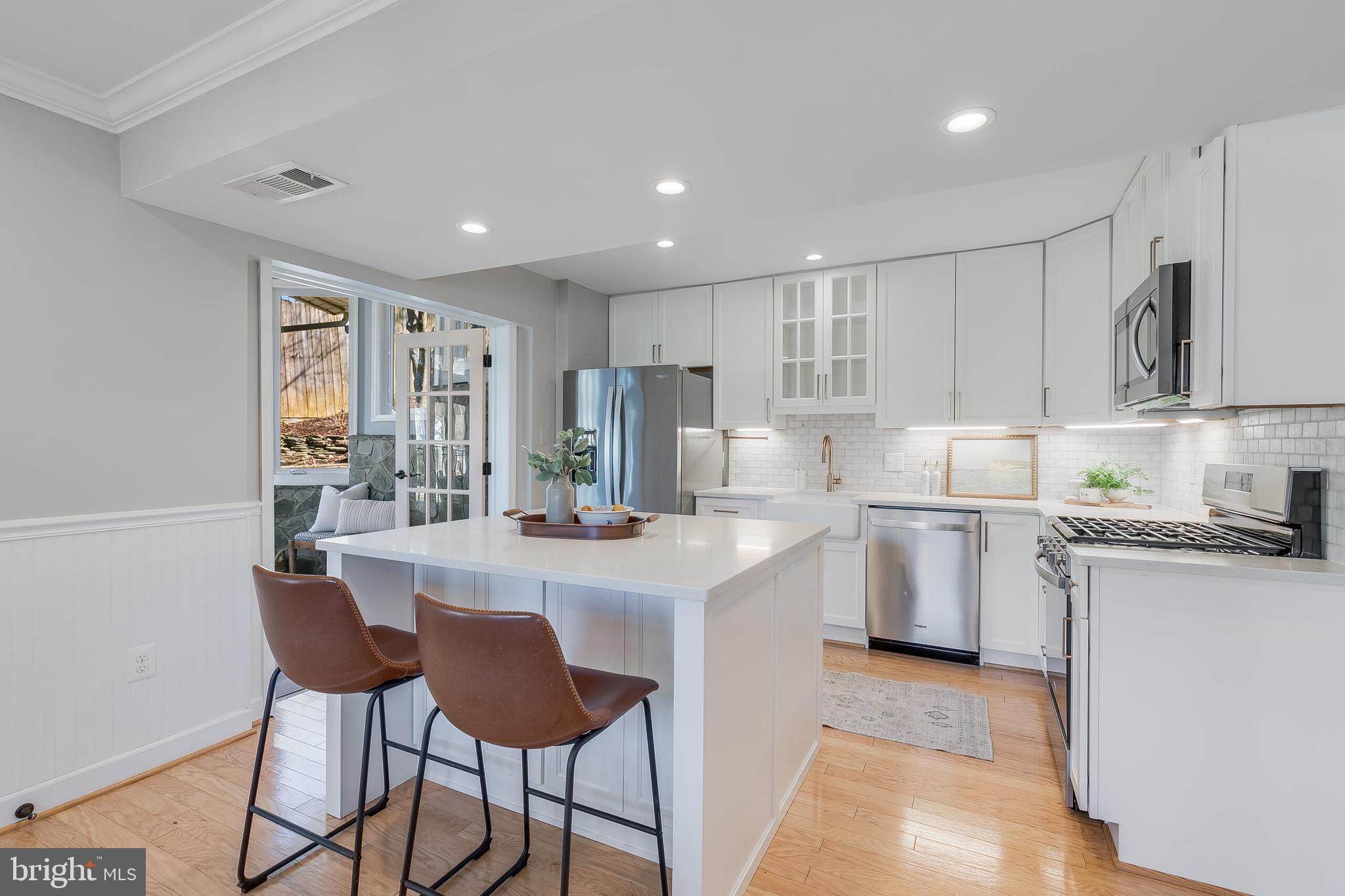 7003 Vancouver Road Springfield, VA 22152 - Photo 10 of 38 a kitchen with granite countertop cabinets and chairs
