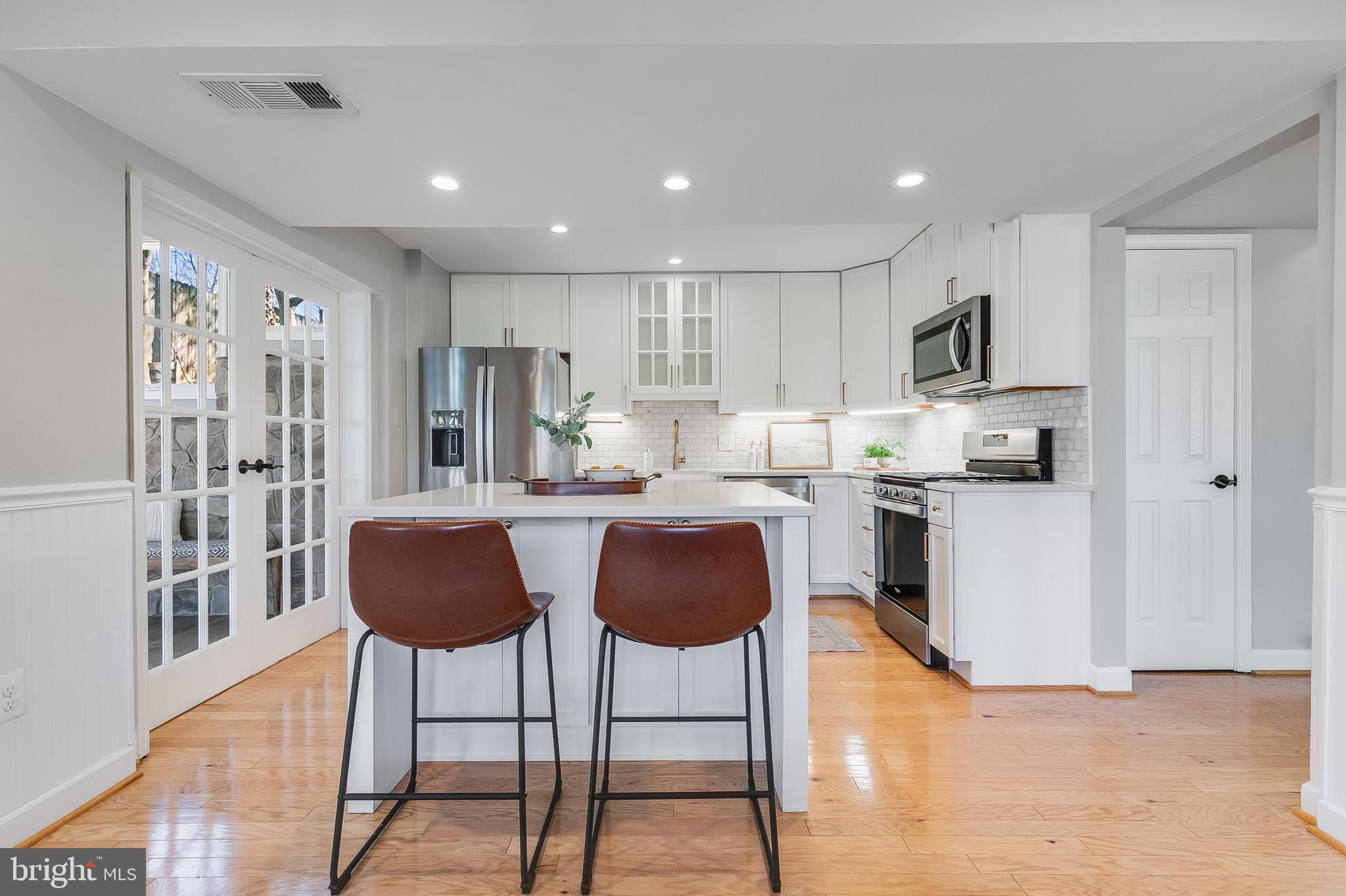 7003 Vancouver Road Springfield, VA 22152 - Photo 12 of 38 a kitchen with granite countertop a counter space a sink stainless steel appliances and cabinets