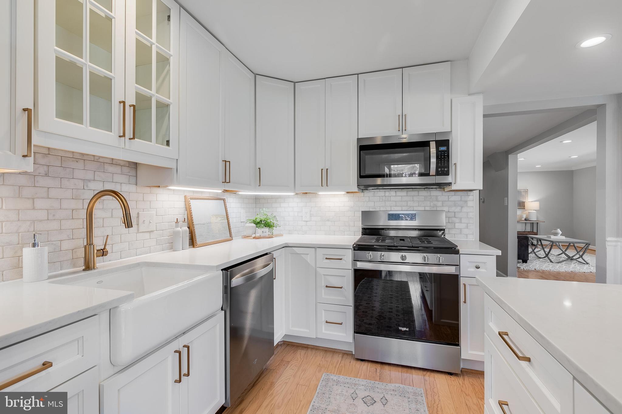 7003 Vancouver Road Springfield, VA 22152 - Photo 13 of 38 a kitchen with stainless steel appliances granite countertop a stove and white cabinets