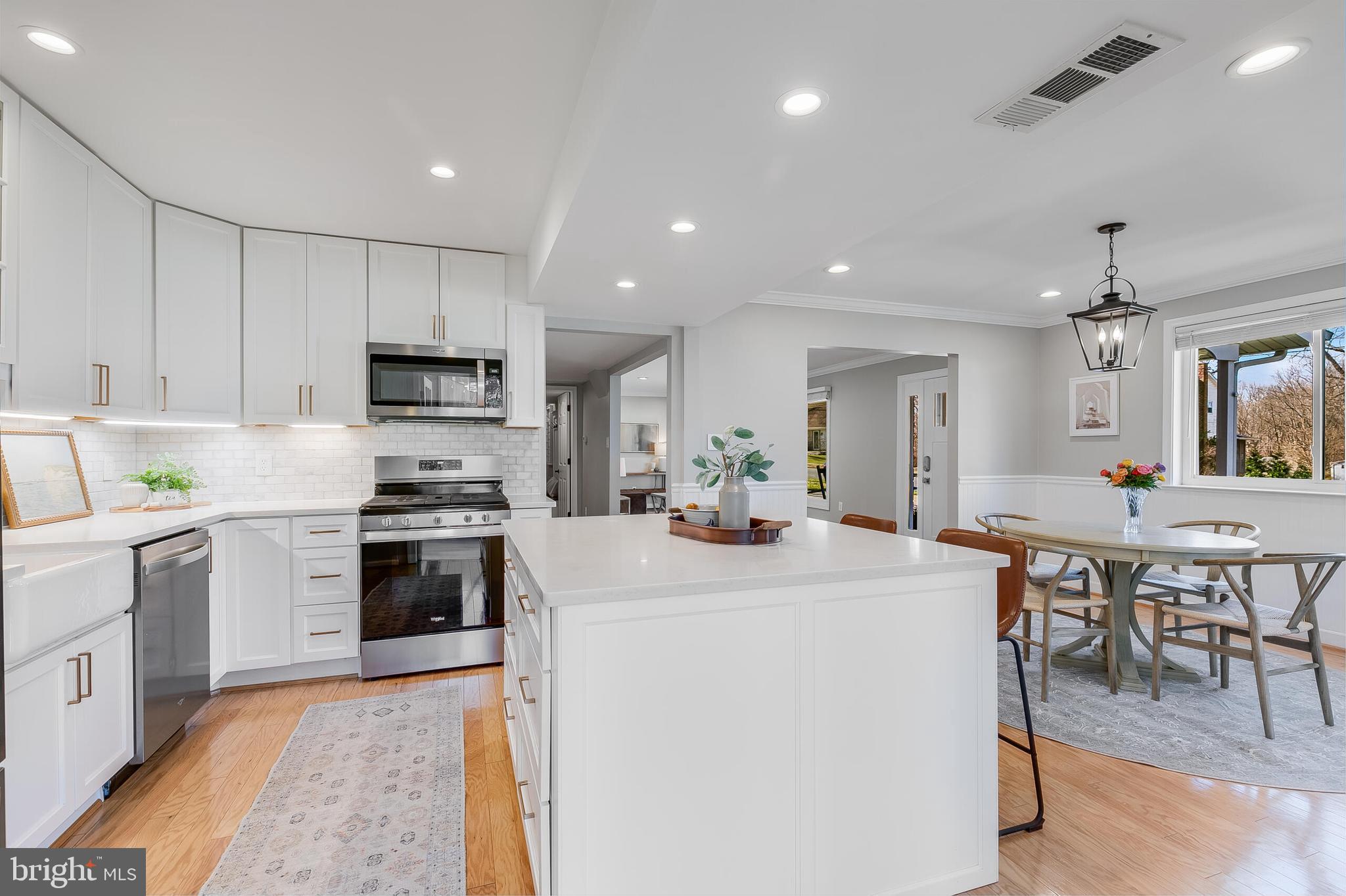7003 Vancouver Road Springfield, VA 22152 - Photo 14 of 38 a kitchen with microwave a stove and chairs