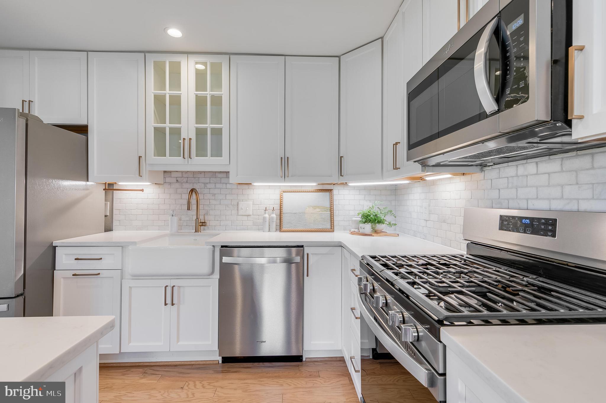 7003 Vancouver Road Springfield, VA 22152 - Photo 15 of 38 a kitchen with stainless steel appliances granite countertop a stove a sink and a microwave