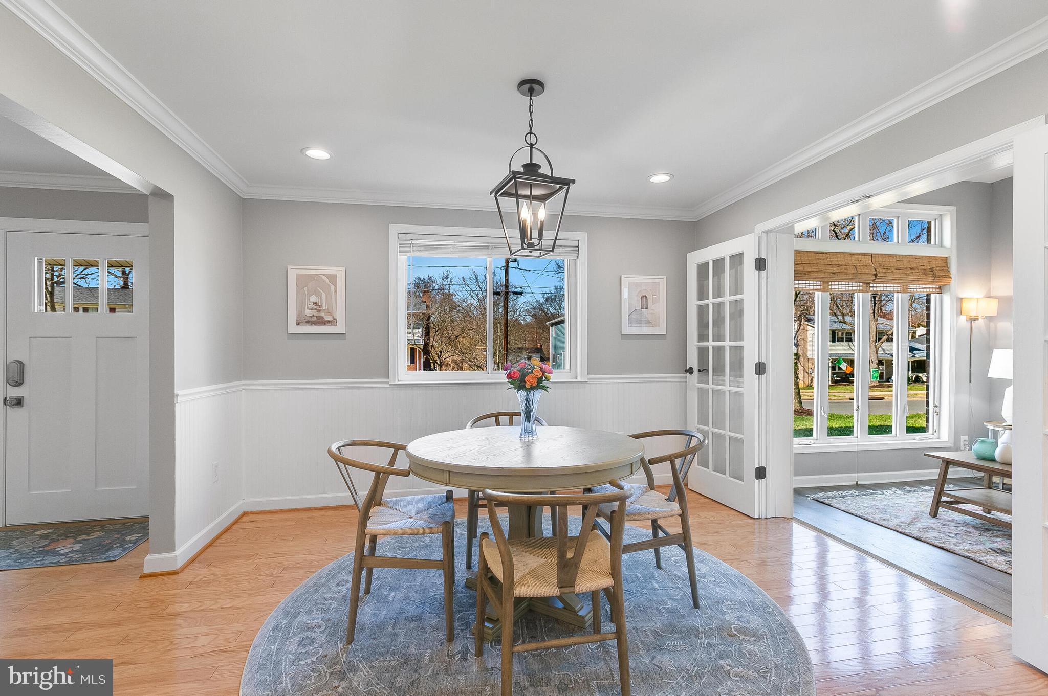 7003 Vancouver Road Springfield, VA 22152 - Photo 16 of 38 a dining room with furniture a chandelier and wooden floor