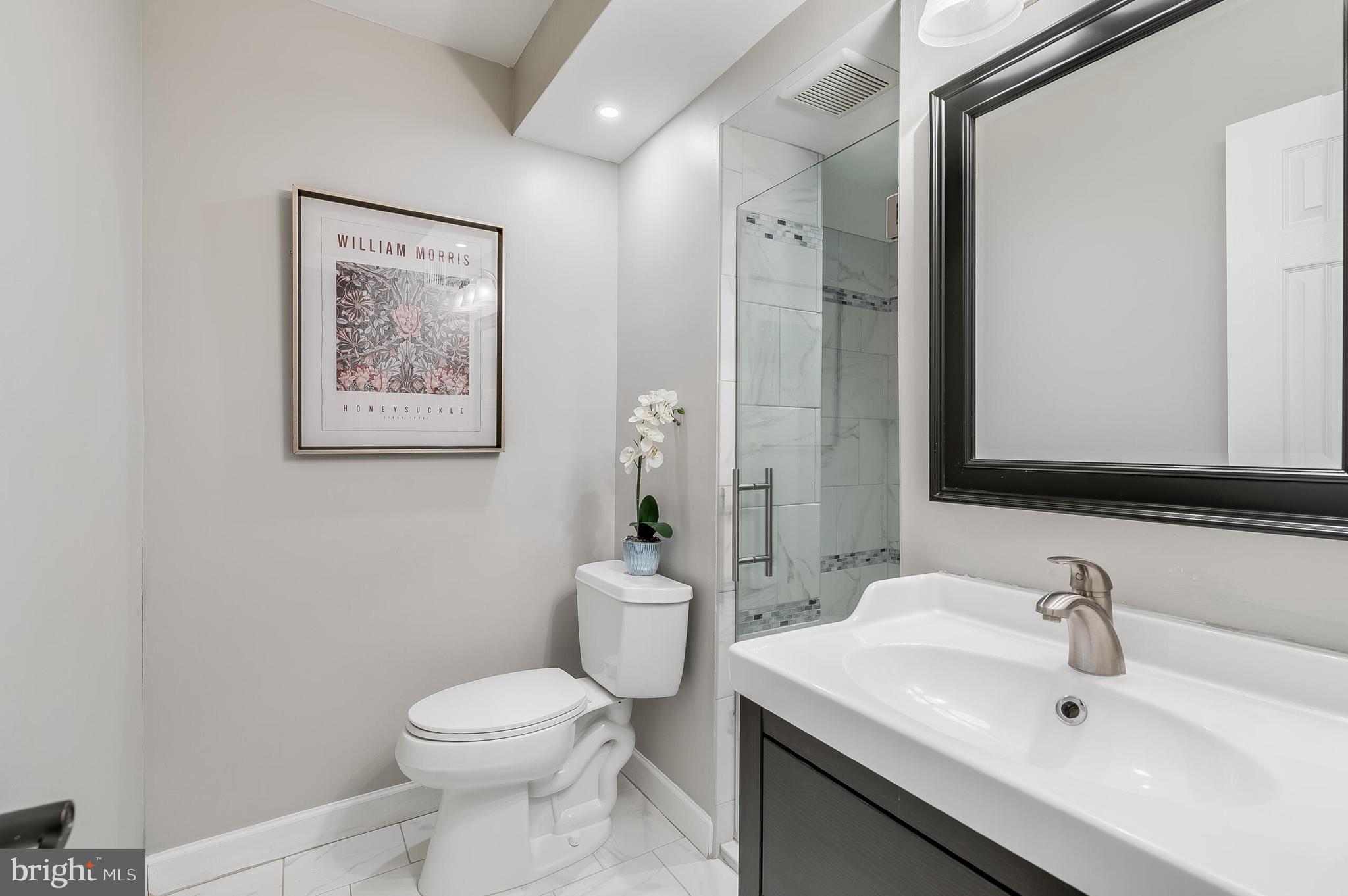 7003 Vancouver Road Springfield, VA 22152 - Photo 19 of 38 a bathroom with a toilet sink and mirror