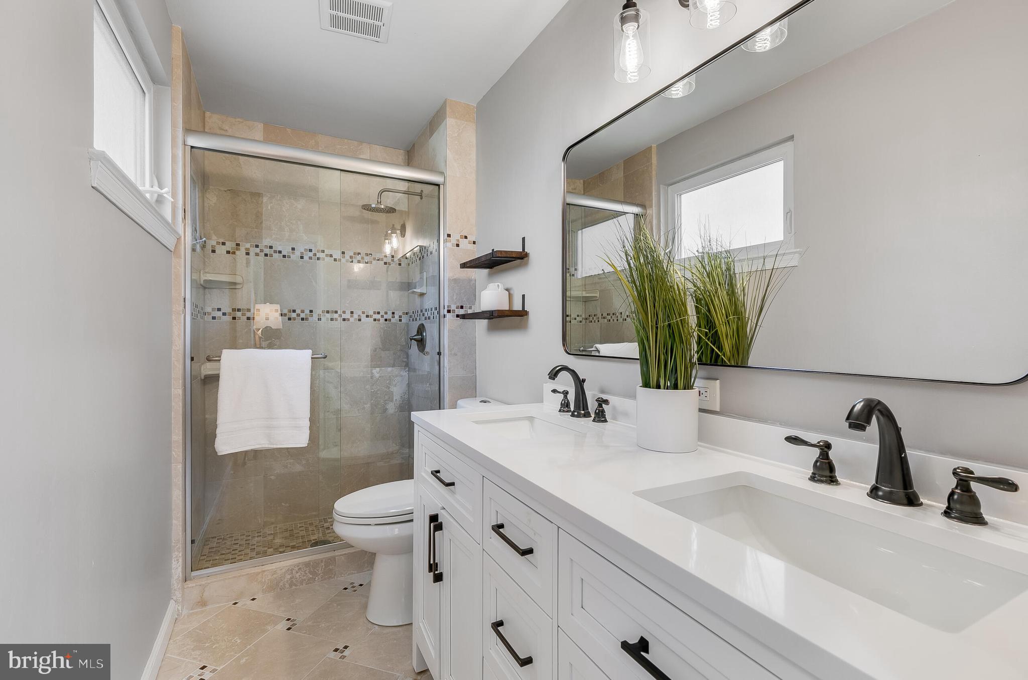 7003 Vancouver Road Springfield, VA 22152 - Photo 28 of 38 a bathroom with a sink a toilet and a mirror