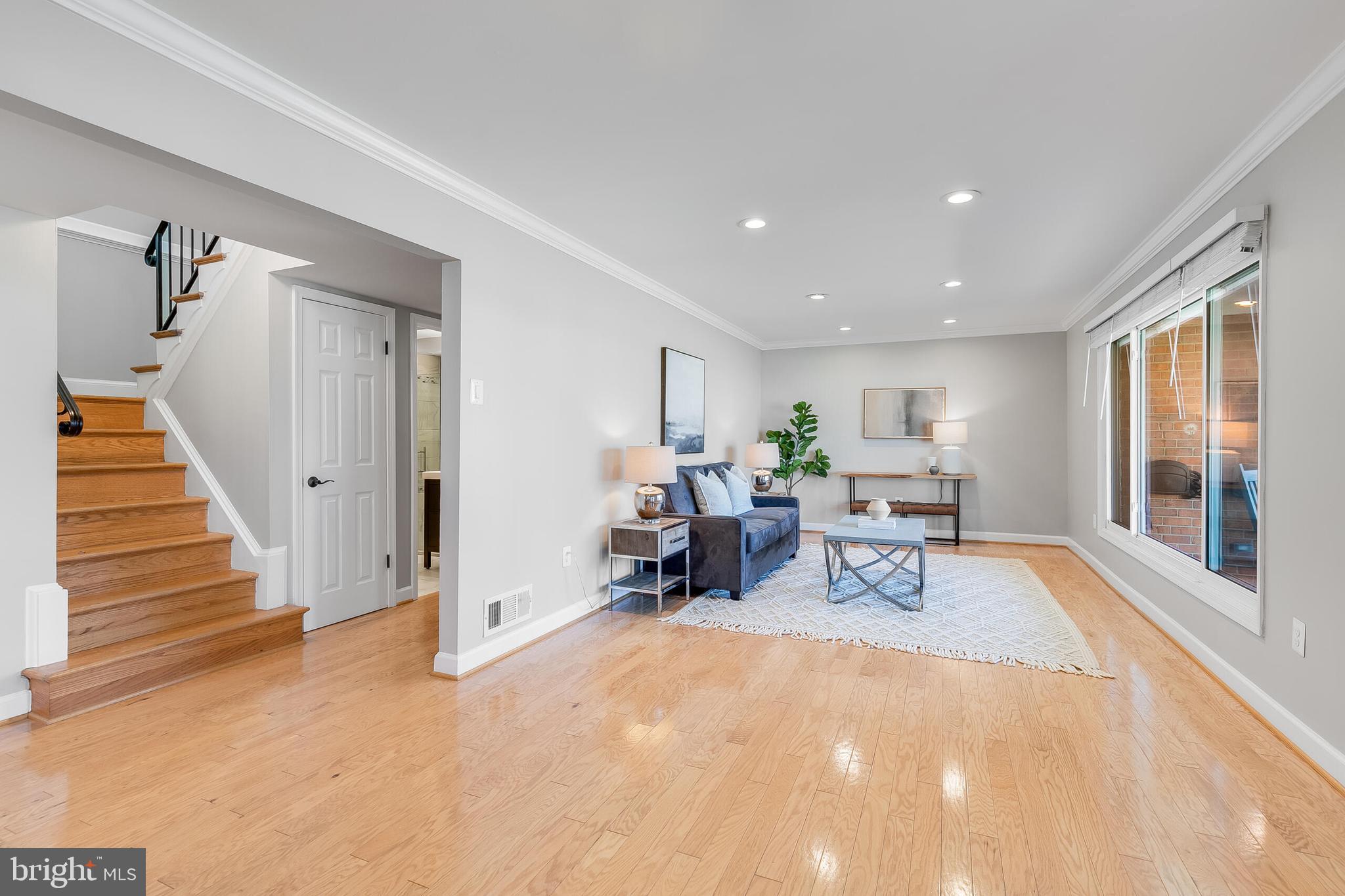 7003 Vancouver Road Springfield, VA 22152 - Photo 3 of 38 a living room with furniture and a table with wooden floor