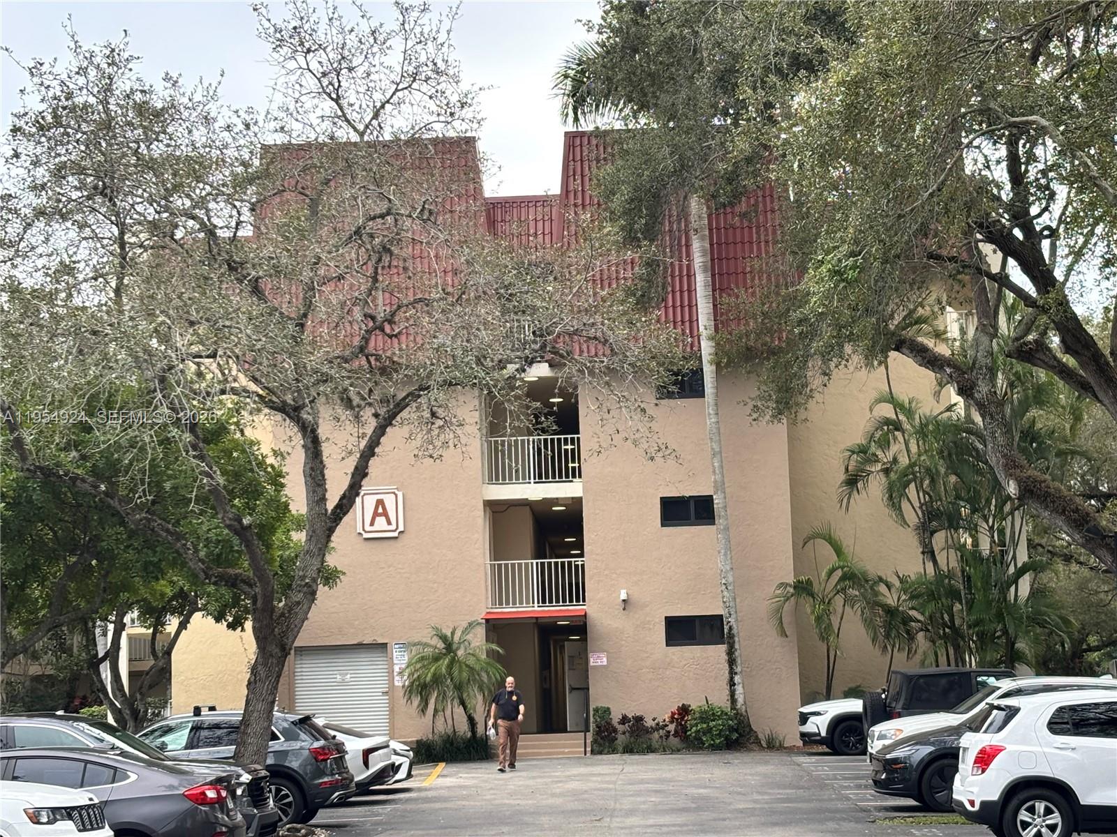 9301 Southwest 92nd Avenue, Unit A320 Miami, FL 33176 - Photo 13 of 20 a building with trees in front of it