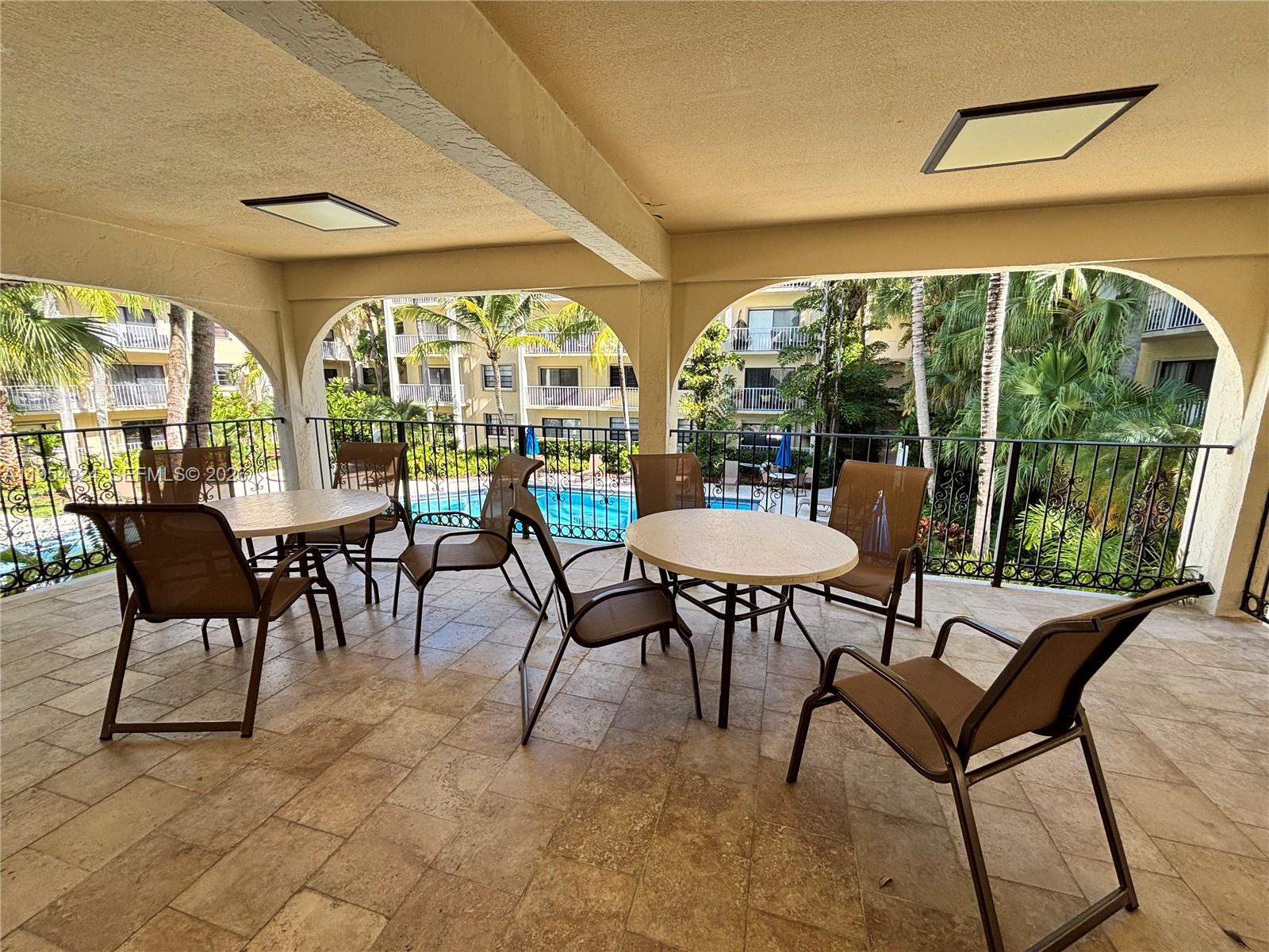 9301 Southwest 92nd Avenue, Unit A320 Miami, FL 33176 - Photo 18 of 20 a view of a dining room with furniture large windows and wooden floor