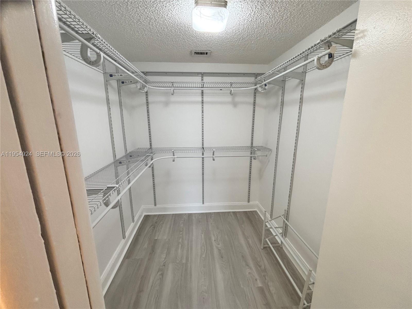 9301 Southwest 92nd Avenue, Unit A320 Miami, FL 33176 - Photo 7 of 20 a view of a room with wooden floor and white walls