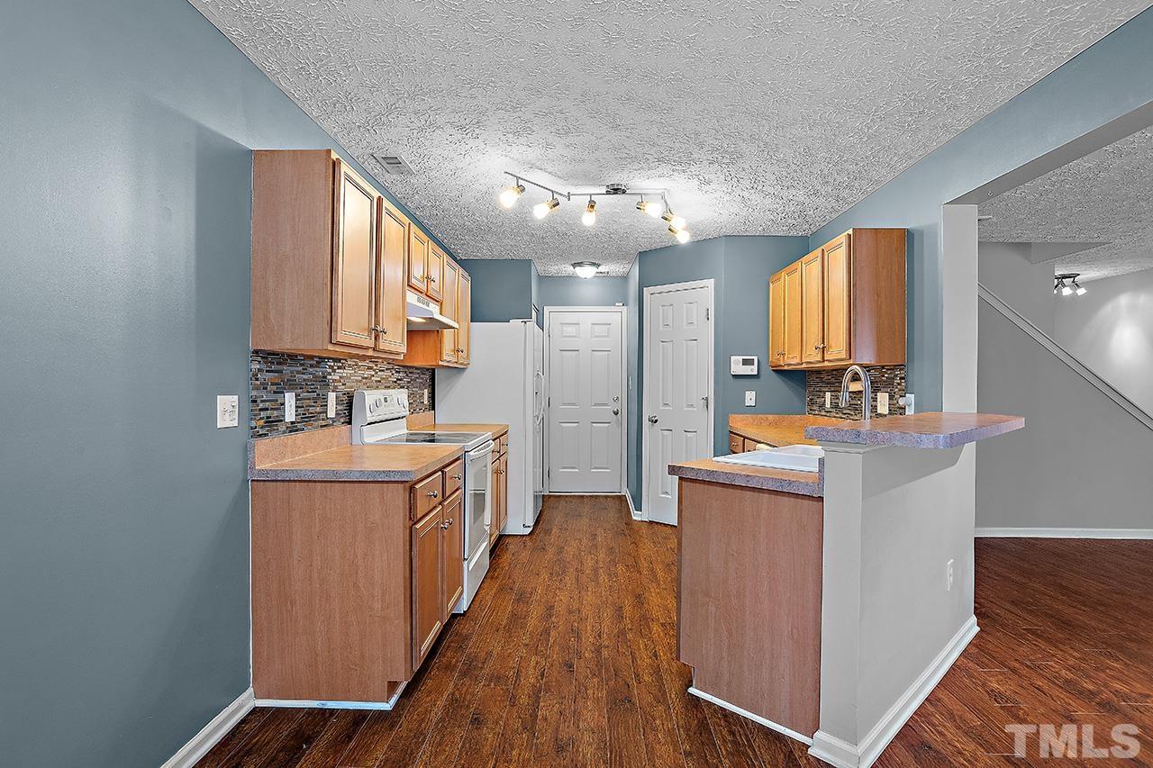 1909 Rathie Drive Durham, NC 27703 - Photo 11 of 32 a kitchen with sink a counter top space and stainless steel appliances