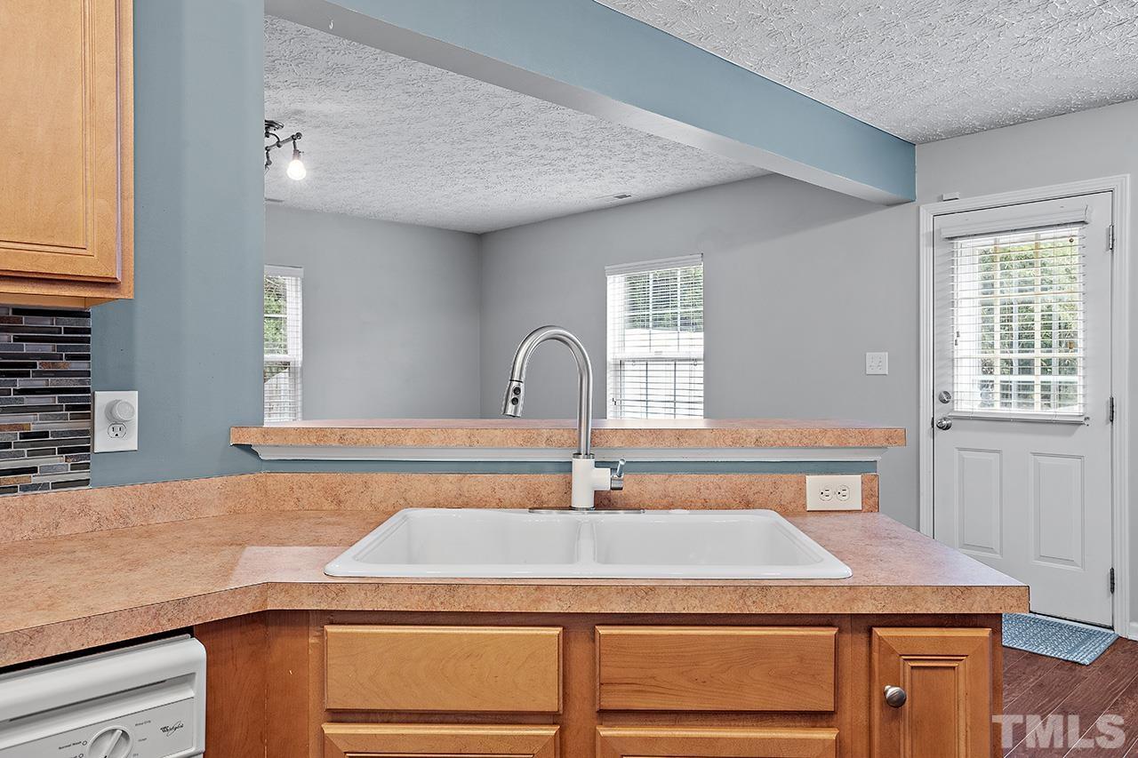 1909 Rathie Drive Durham, NC 27703 - Photo 13 of 32 a room with a sink and a mirror