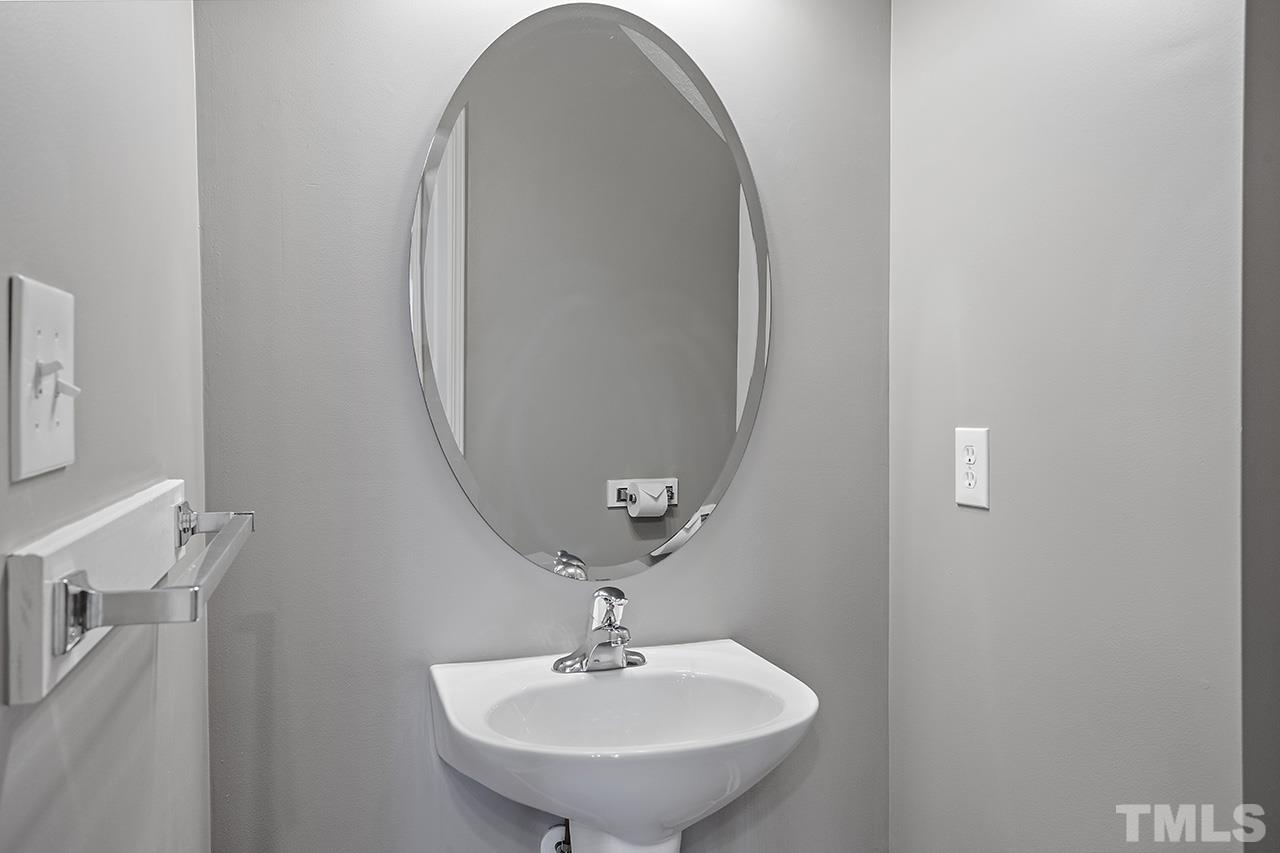 1909 Rathie Drive Durham, NC 27703 - Photo 15 of 32 a bathroom with a sink and a mirror