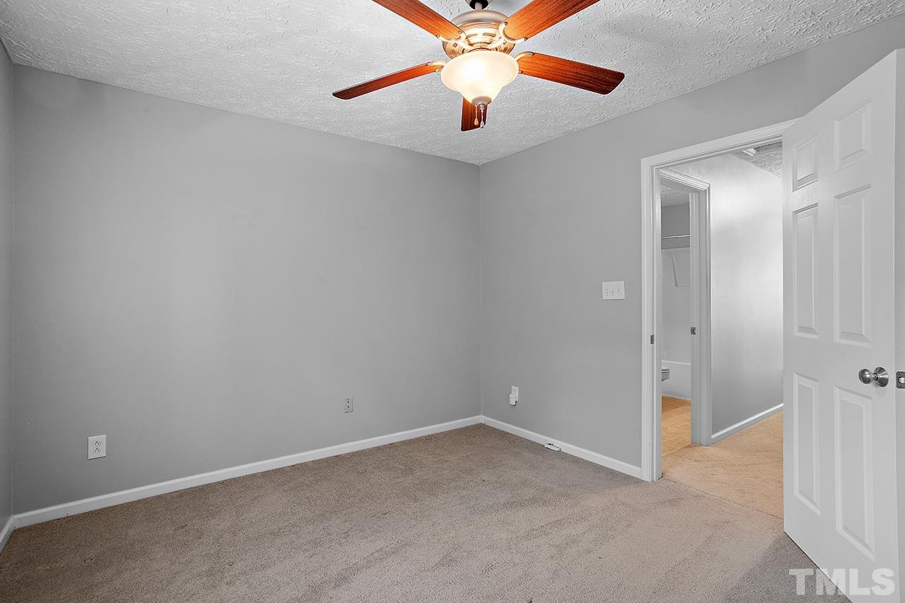 1909 Rathie Drive Durham, NC 27703 - Photo 19 of 32 an empty room with chandelier fan and windows