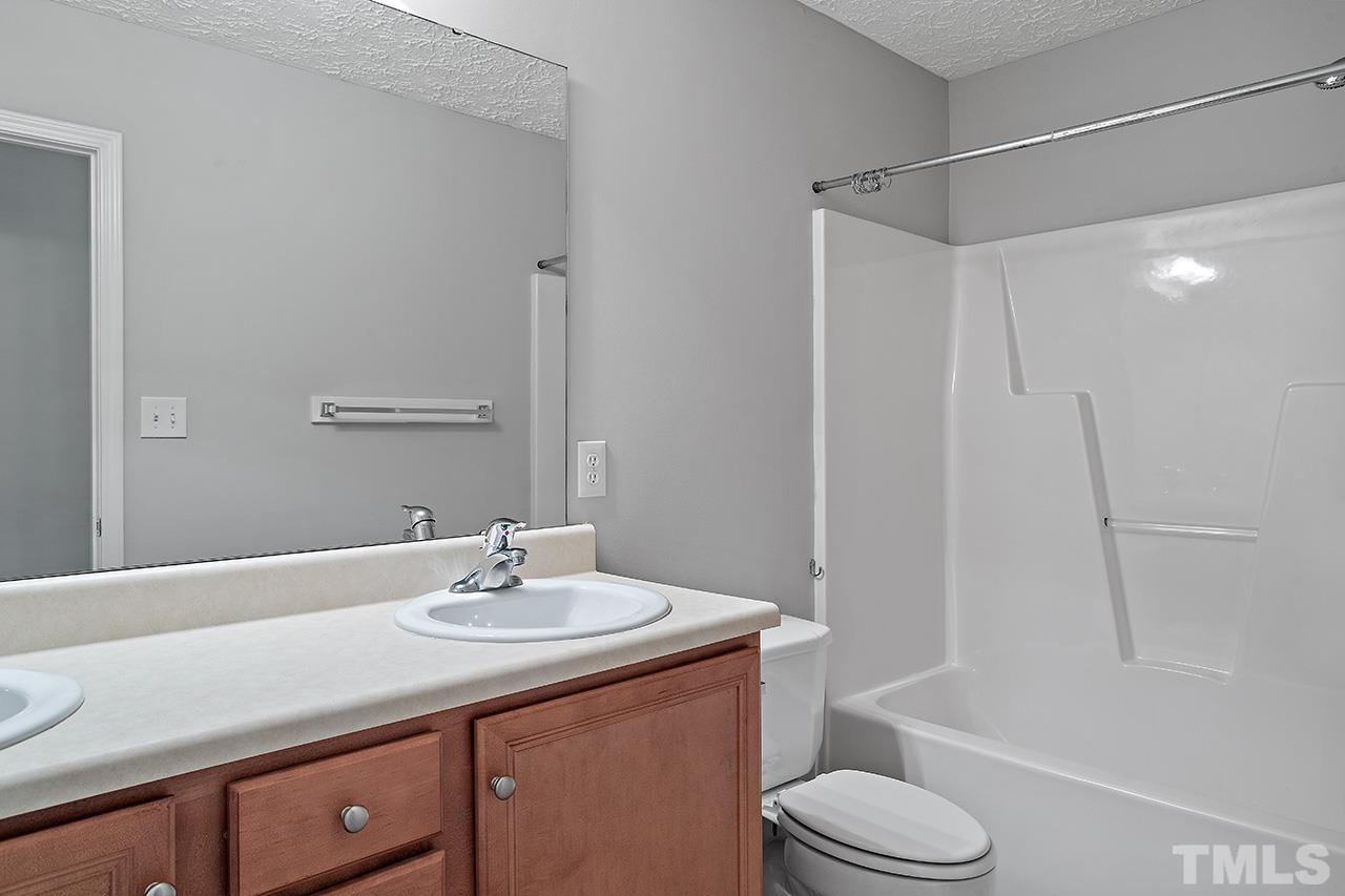1909 Rathie Drive Durham, NC 27703 - Photo 20 of 32 a bathroom with a sink a toilet and shower