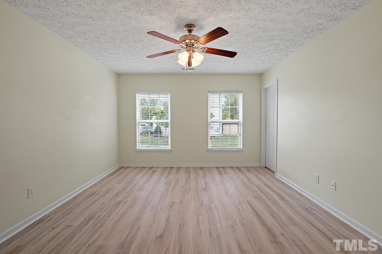 1909 Rathie Drive Durham, NC 27703 - Photo 21 of 32 a view of an empty room with wooden floor and a window