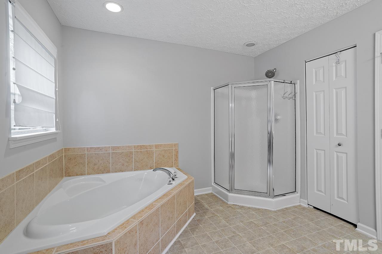 1909 Rathie Drive Durham, NC 27703 - Photo 24 of 32 a white bath tub sitting in a bathroom