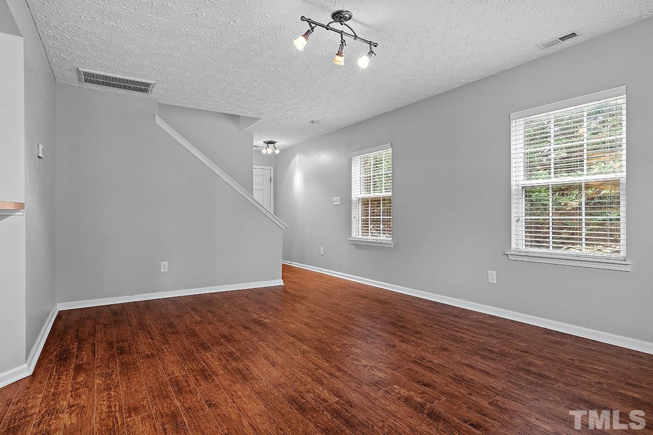 1909 Rathie Drive Durham, NC 27703 - Photo 5 of 32 wooden floor in an empty room with a window
